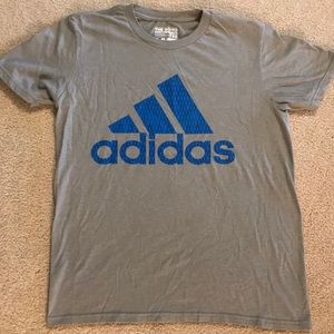 Light grey Adidas shirt with blue logo.